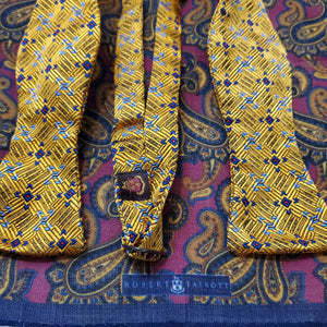 Gold and blue bowtie with complimenting paisley pocket square by Robert Talbott